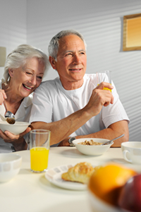 senior couple eating breakfast